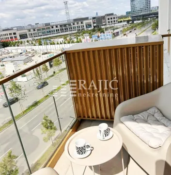 Furnished balcony with a small table, cups and a city view. - image 9