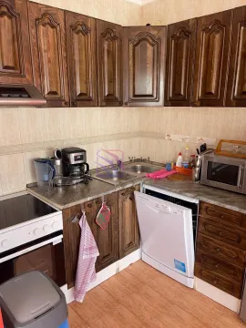 Kitchen equipped with wooden cabinets and home appliances. - image 6