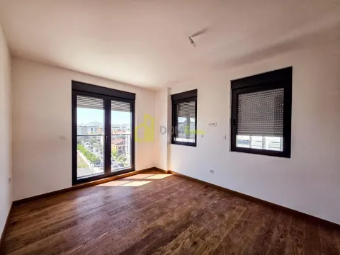 Empty room with wooden flooring and windows overlooking the street. - image 16