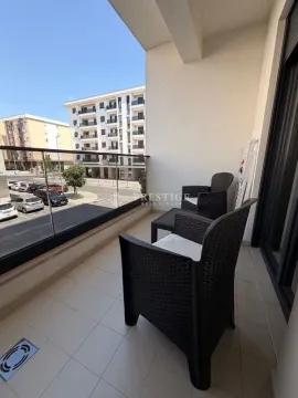 Covered terrace with outdoor seating furniture and a city view. - image 10