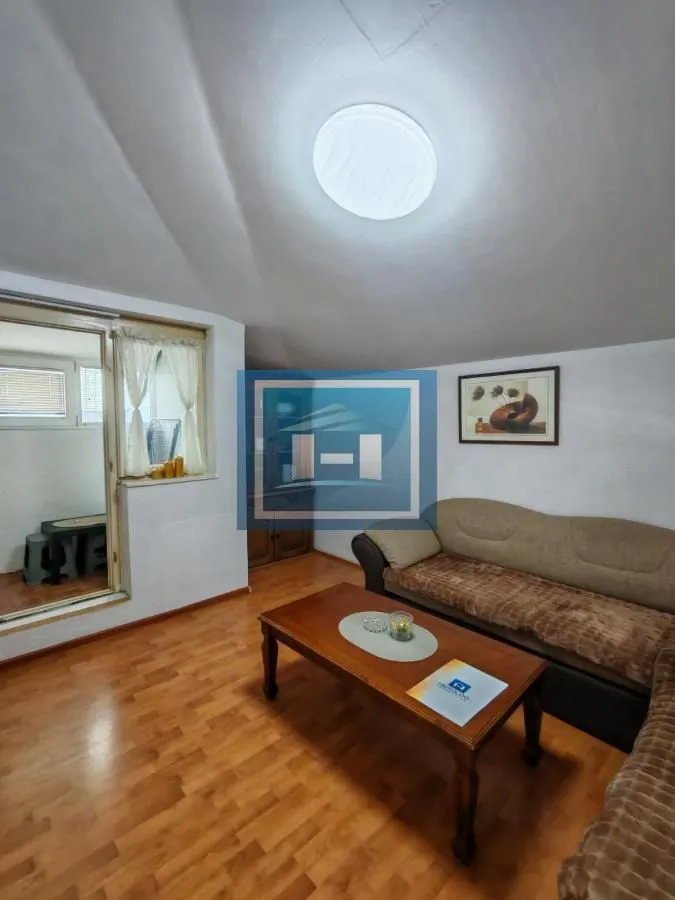 Living room with a sofa, coffee table, and access to the terrace.