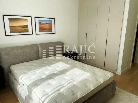 Bedroom with a double bed, wardrobe, and wall art. - image 5