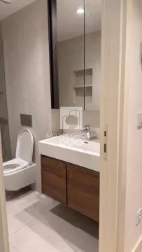 Modern bathroom with a washbasin, mirror, and toilet. - image 19