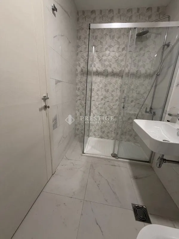 Modernly equipped bathroom with a walk-in shower.