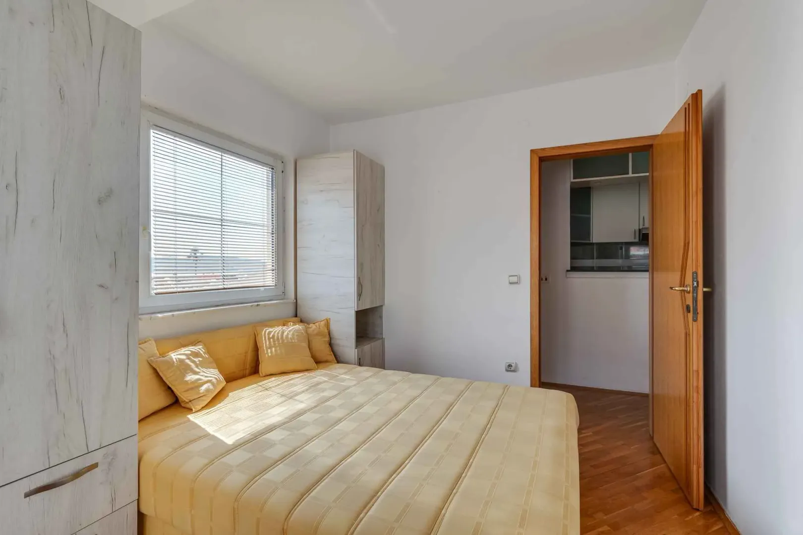 Bright bedroom with a double bed and a window.