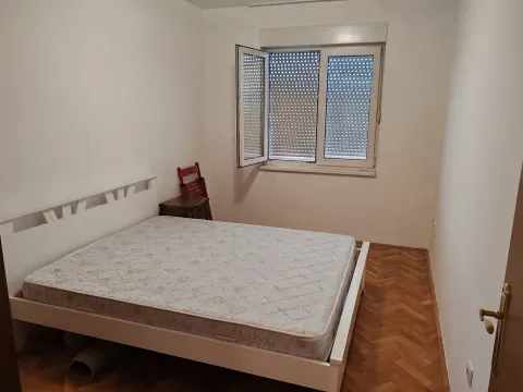 Small bedroom with a double bed, parquet flooring, and an open window. - image 5