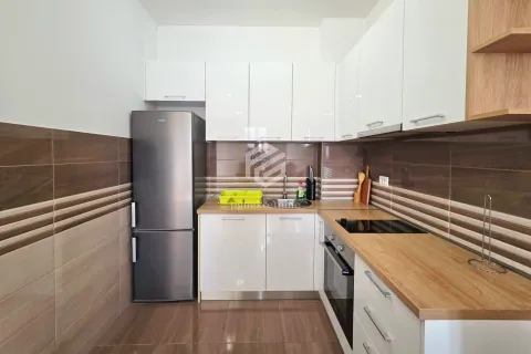 Kitchen equipped with white cabinets, wooden countertops and a refrigerator. - image 6