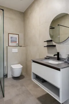 Modern bathroom with a walk-in shower, washbasin, and wall-mounted toilet. - image 15