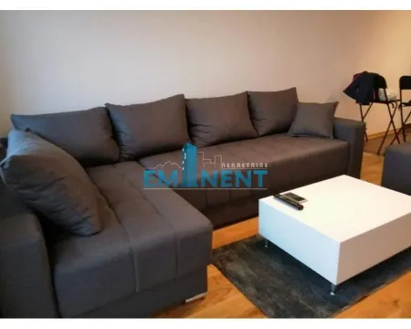 Living room with a corner sofa and coffee table. - image 11