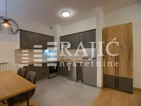 Modern kitchen with a dining area and built-in appliances. - image 2