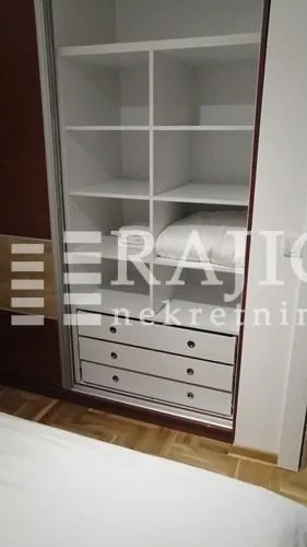 Built-in wardrobe in the bedroom with shelves and drawers.