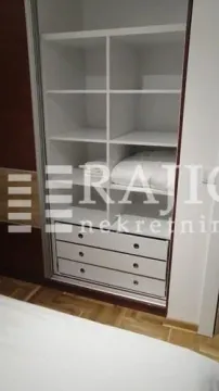 Built-in wardrobe in the bedroom with shelves and drawers. - image 6