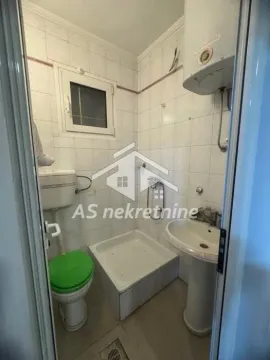 Small bathroom with a shower stall, washbasin and toilet. - image 30