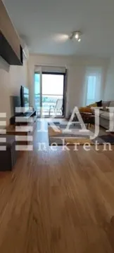 Living room with a sofa, TV, and access to the terrace. - image 3