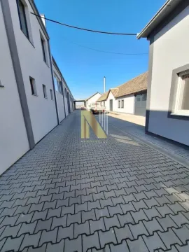 Paved courtyard between buildings. - image 5