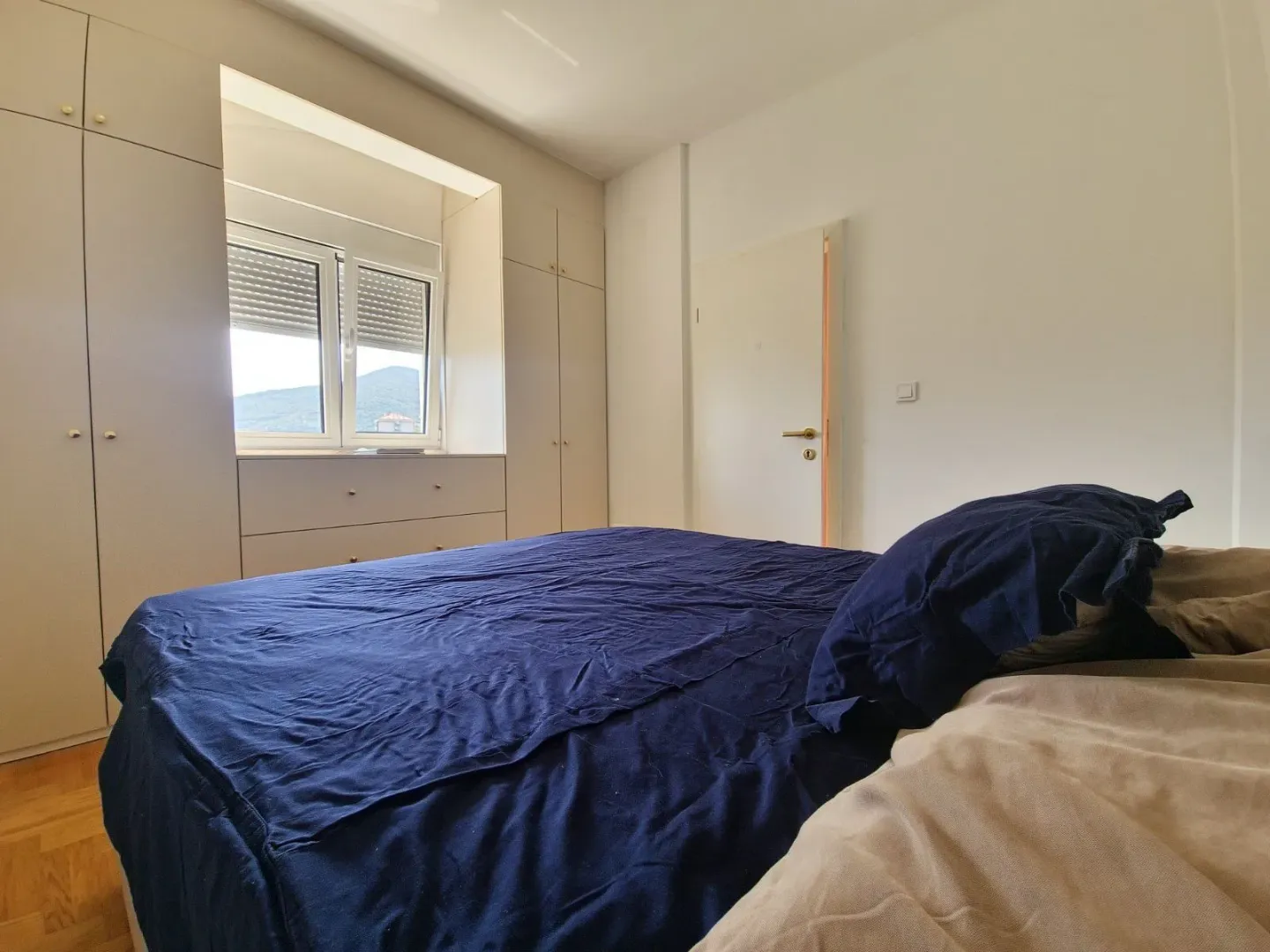 Bedroom with a double bed and built-in wardrobes.