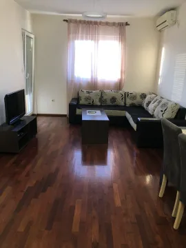 Bright living room featuring a corner sofa and wooden flooring. - image 2
