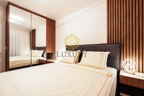 Modern bedroom with a double bed, wooden wall panels, and a large mirror. - image 7