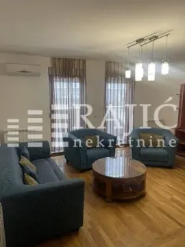 Furnished living room with a sofa, armchairs, and a wooden coffee table. - image 3