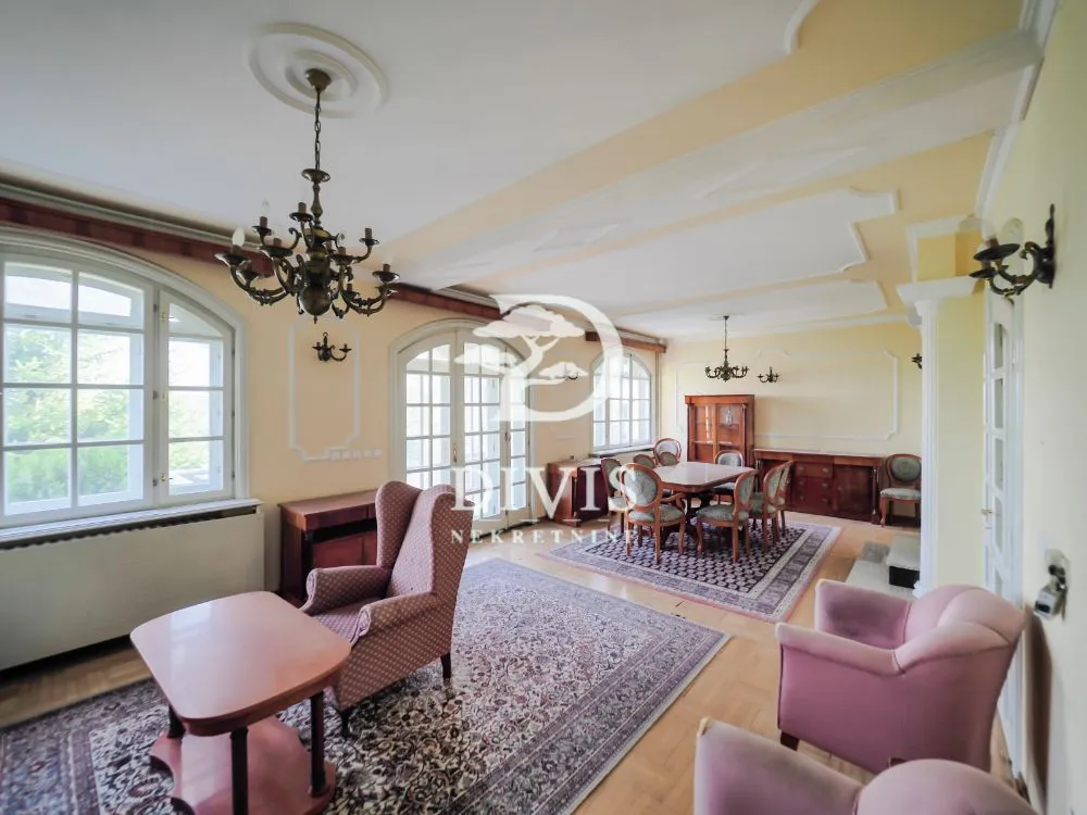 Spacious living room with a seating area and a dining space.