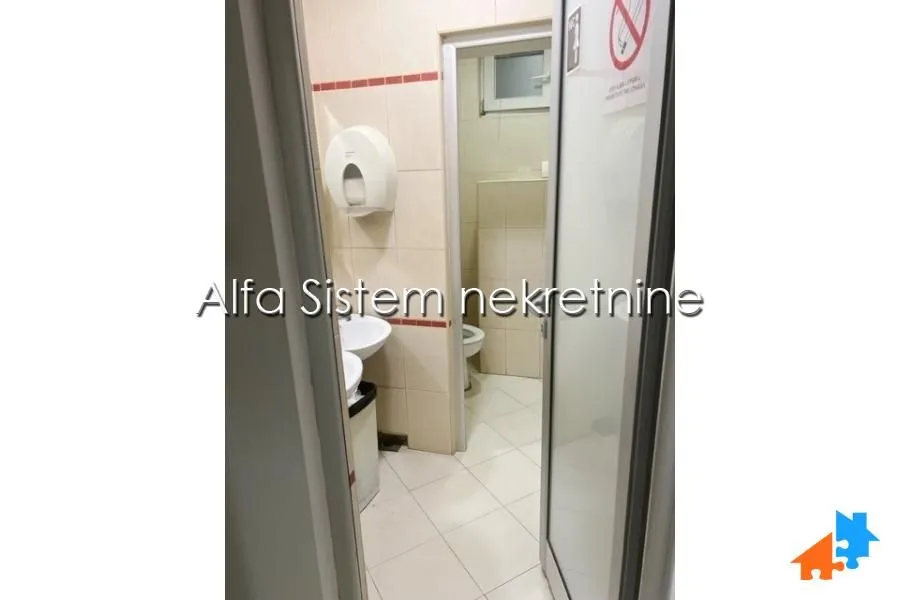 View of the bathroom with a sink and tiles.
