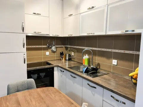 Kitchen with white cabinetry, sink, and built-in oven. - image 5