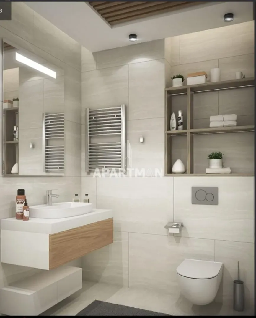 Modernly equipped bathroom with a washbasin, toilet bowl, and wall shelving.