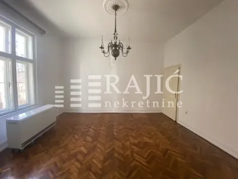Empty room with parquet flooring, a chandelier, and a window. - image 2