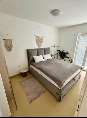 Bright bedroom with a double bed and decorative wall details.