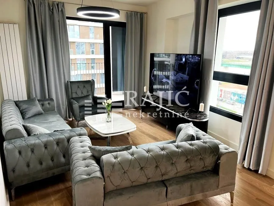 Modern and bright living room with a sofa set and large windows.