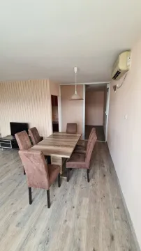 Living room with a dining table and chairs. - image 2