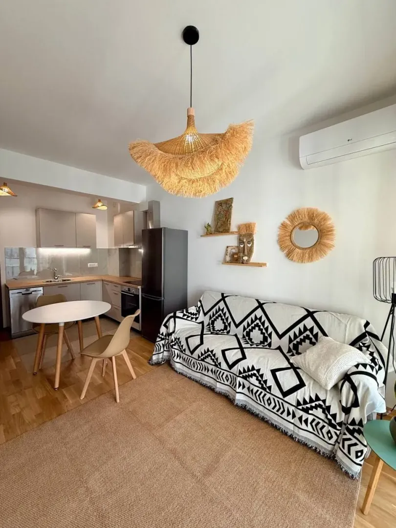 Living room with a sofa and a dining area.