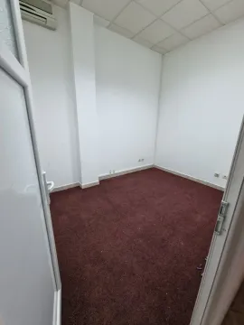 An empty room with red carpeting and white walls. - image 6
