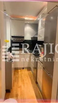 Smaller modern kitchen with wooden flooring. - image 6