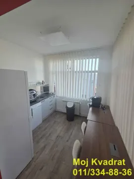 Smaller kitchen with workspace elements and a dining table. - image 13