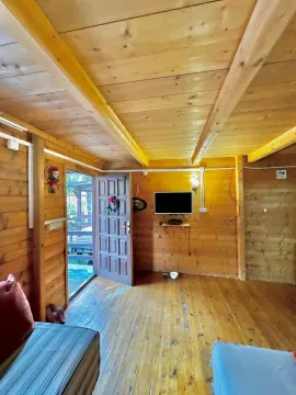 Interior of a wooden cottage with an open door and wooden walls. - image 4
