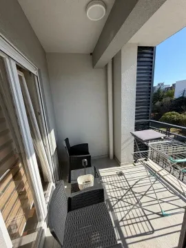 Unfurnished balcony with seating set and drying rack. - image 9