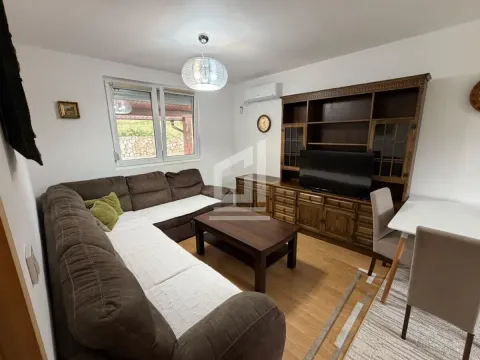 Living room with a sectional sofa, wooden furniture, and a dining table. - image 3