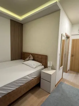 Furnished bedroom with a double bed and a nightstand. - image 2