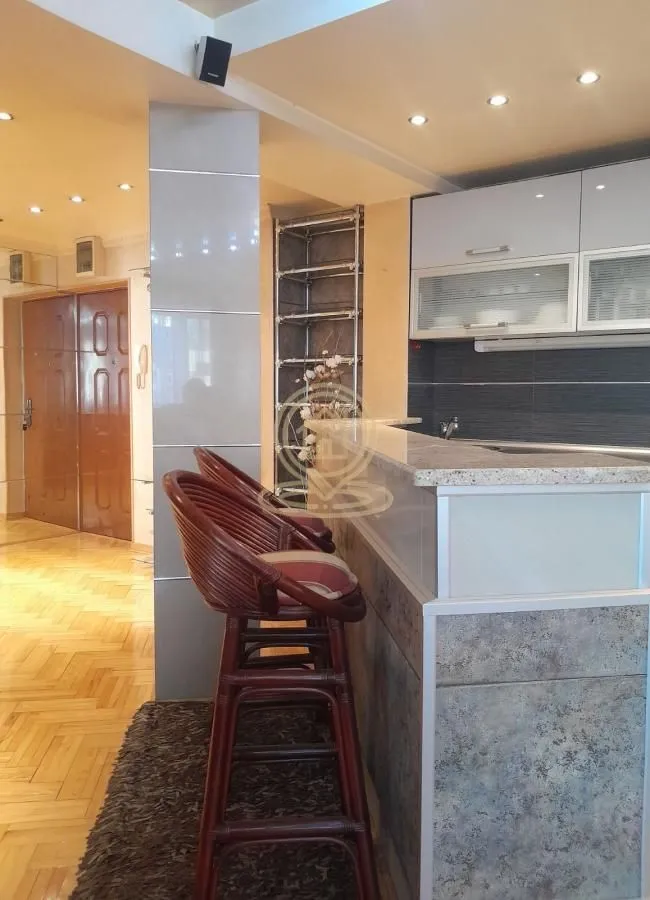 Kitchen with a breakfast bar and wooden bar stools.
