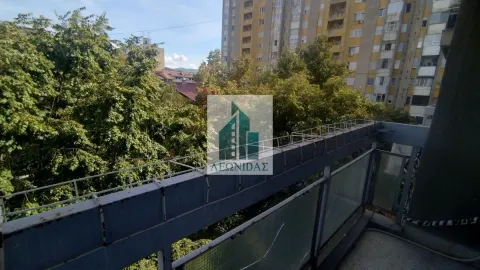View from the balcony overlooking surrounding greenery and buildings. - image 15