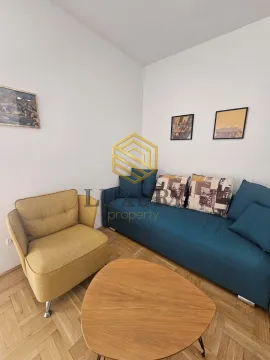 Living room with a blue sofa, yellow armchair and wooden coffee table. - image 3