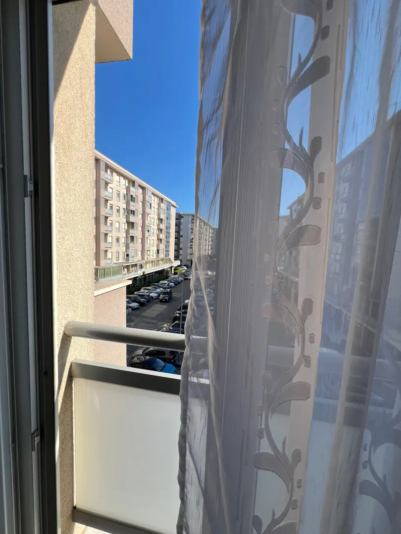 View from the terrace overlooking surrounding buildings and parking.