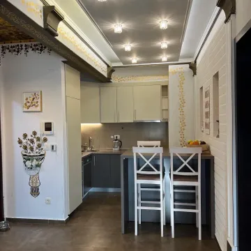 Small kitchen with a dining area and a breakfast bar. - image 3