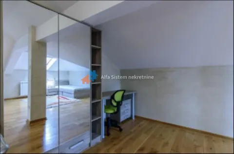 Attic bedroom with a bed, desk, and a large mirror integrated into the wardrobe. - image 13