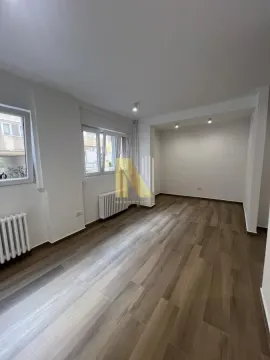 Empty room with light walls and wooden flooring. - image 6