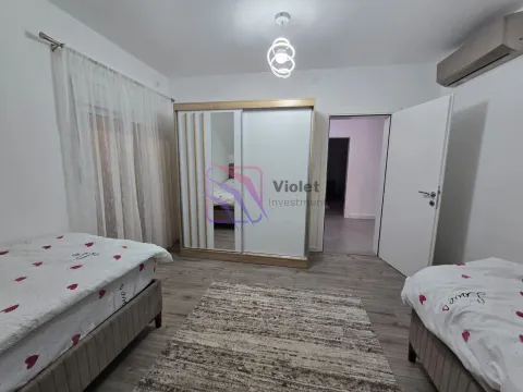Bedroom with two beds, wardrobe, and a rug. - image 7