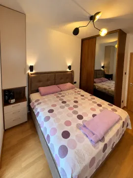 Furnished bedroom with a double bed, wardrobes, and built-in lighting. - image 6