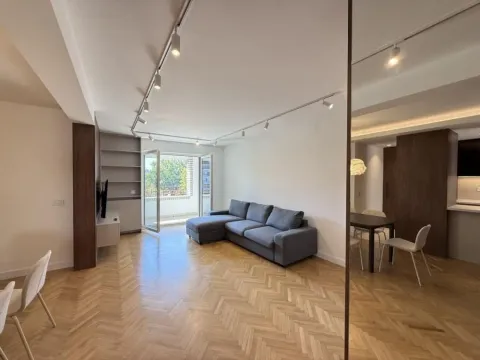 Spacious living room with a sectional sofa, hardwood flooring, and access to the terrace. - image 10