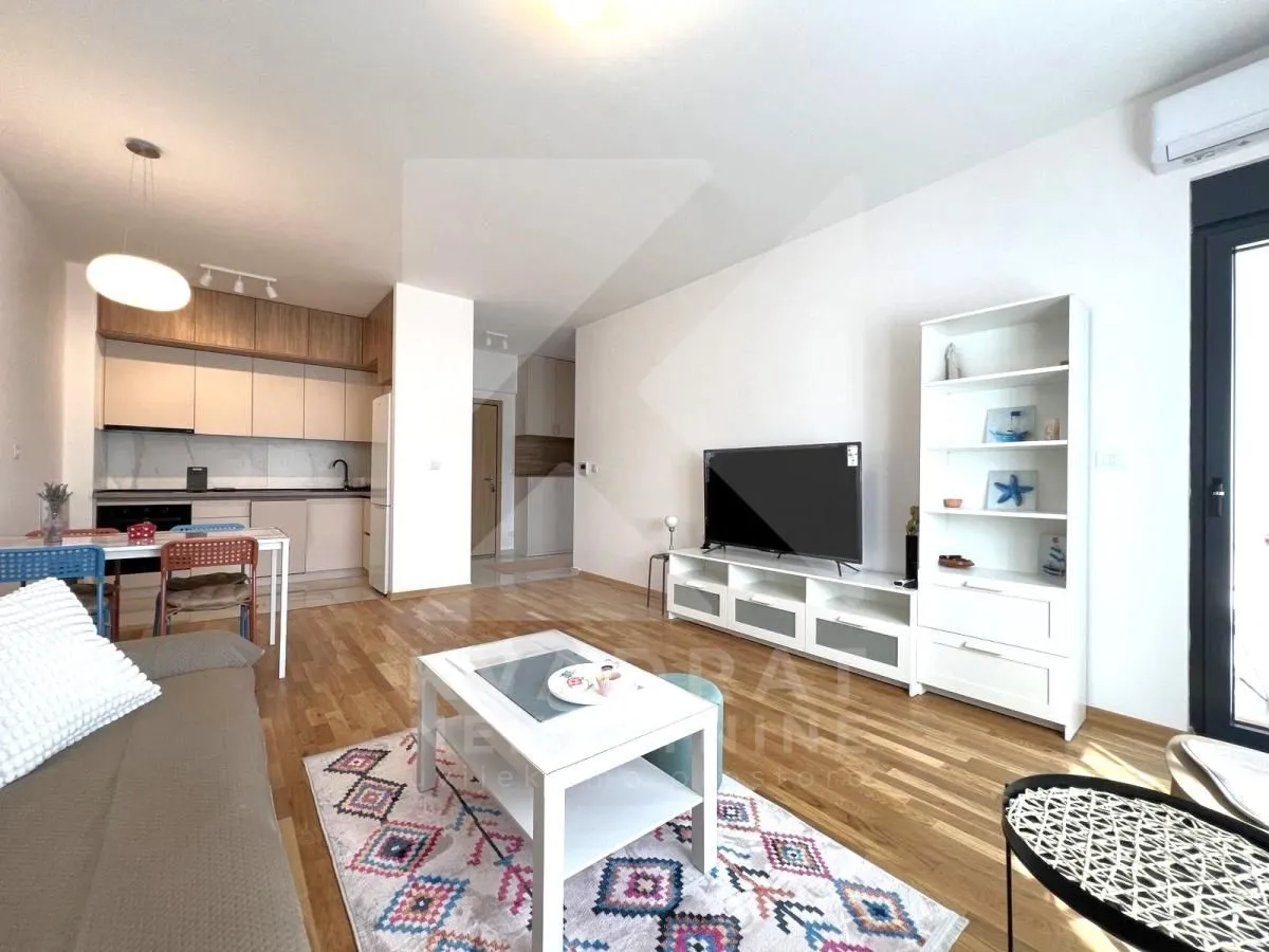 Living room with dining area and kitchen in an open space layout.
